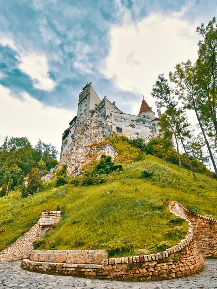 Bran Castle — the white stone fortress on a 200-foot rocky outcrop above the Bran Gorge, Transylvania, Romania